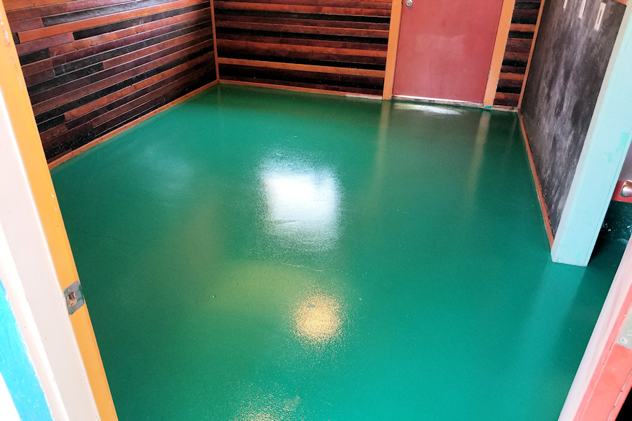 Close up view of light colored, granular looking epoxy floor.